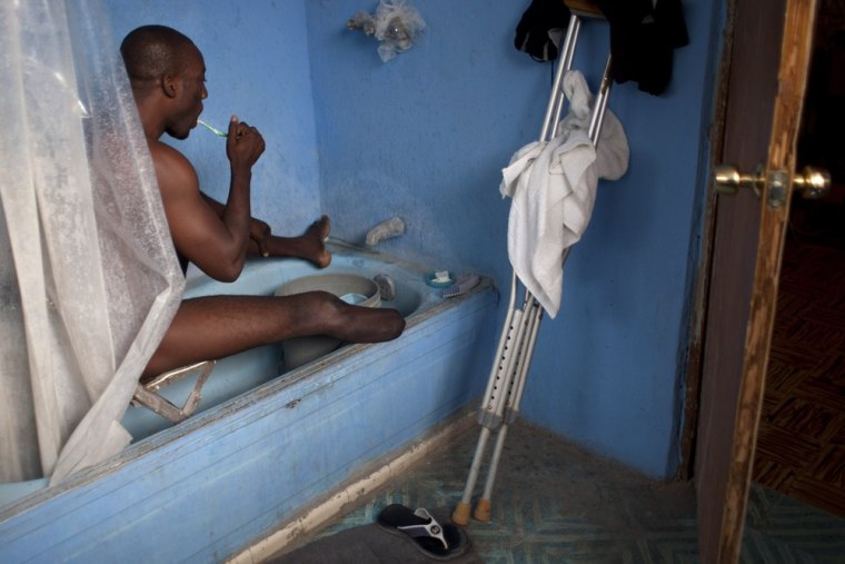 Exantus bathes as he prepares for a concert in Port-au-Prince.