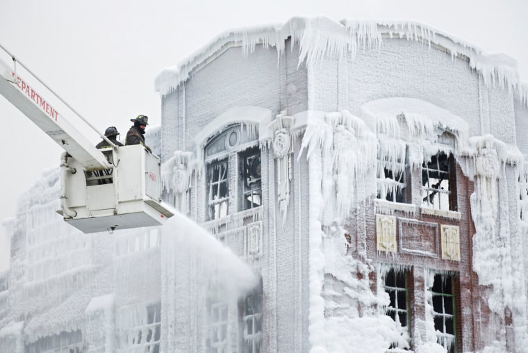 Firefighters spray down hot spots on an ice covered warehouse that caught fire Tuesday night in Chicago on Jan. 23. Fire department officials said it is the biggest fire the department has had to battle in years and one-third of all Chicago firefighters were on the scene at one point or another trying to put out the flames.