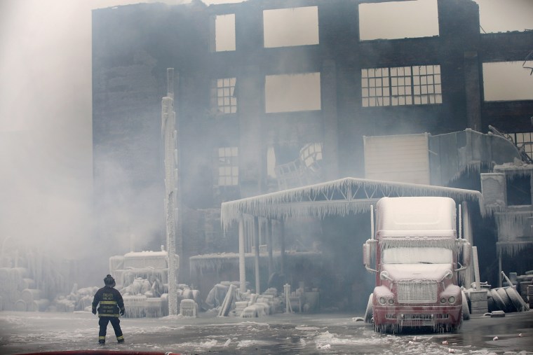 Firefighters work to extinguish a massive blaze at a vacant warehouse on Jan. 23 in Chicago.