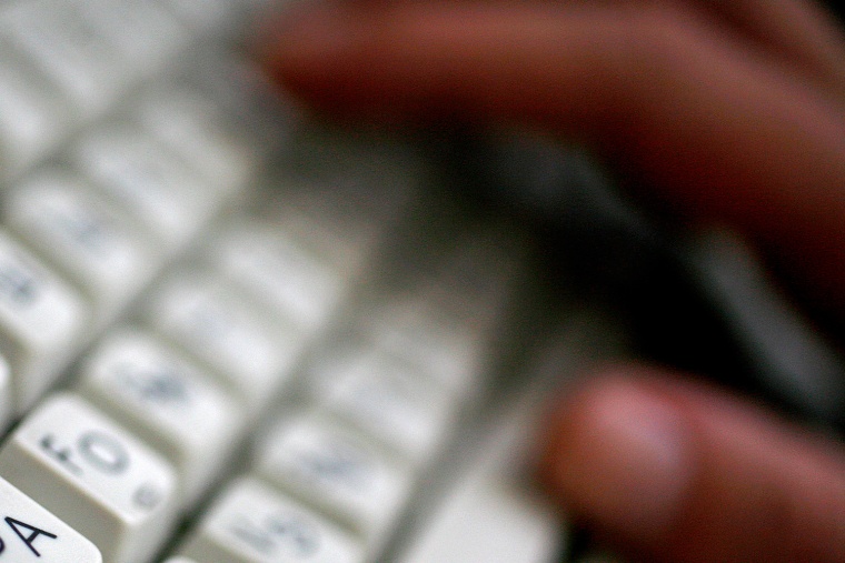 An employee types on a computer keyboard with both Latin and Cyrillic letters in Sofia in this June 23, 2008, file photo. The regulatory body that ove...