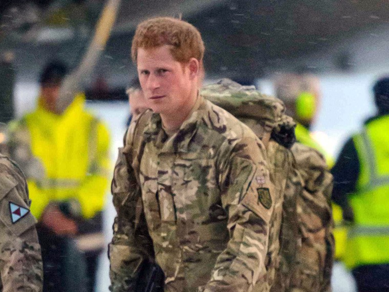 Prince Harry walks after disembarking from a  transport aircraft at RAF Brize Norton in England on Wednesday.