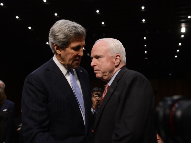 Senator John Kerry, D-Mass., President Barack Obama's nominee for Secretary of State, speaks with Sen. John McCain, R-Ariz., before he testifies at the Senate Foreign Relations committee during his confirmation hearing on Capitol Hill in Washington, DC, on Jan. 24, 2013.