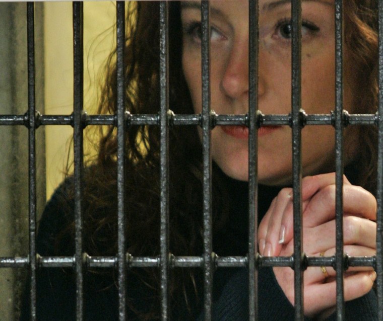 French national Florence Cassez listens to her lawyer behind bars on Jan. 22, 2008 in Mexico City. Mexico's Supreme Court ordered yesterday, the immediate release of Cassez serving 60 years in prison for kidnapping, ruling that authorities had violated her legal rights.