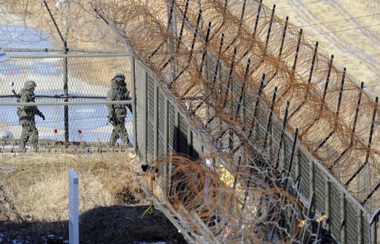 South Korean soldiers patrol along a fence in Paju near the Demilitarized Zone dividing the two Koreas Friday.
