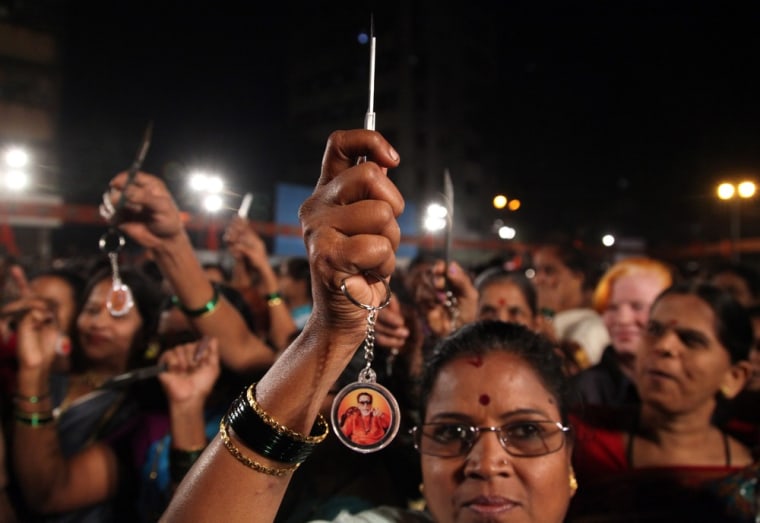 Indian women hold up knives that were distributed by the Shiv Sena party in Mumbai, India, on Wednesday.