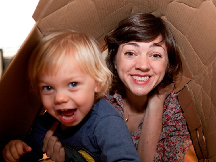 Hattie Garlick, who has taken a no-spending vow for 2013, plays with her 2-year-old son Johnny in a cardboard box.