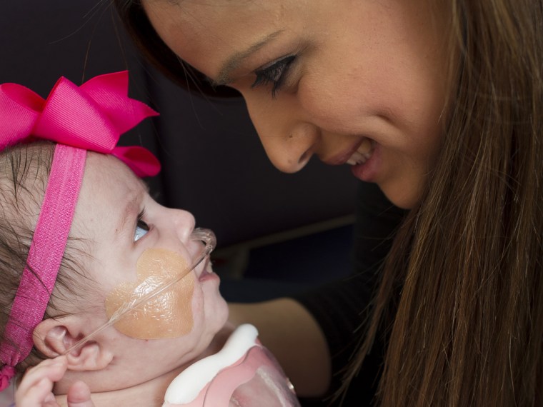 Ashley Cardenas prepares her 3 month-old daughter Audrina to leave Texas Children's Hospital.