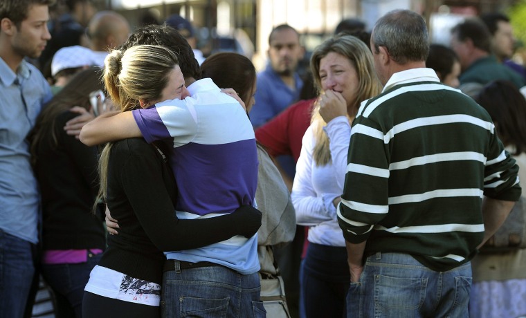 Relatives of those trapped in a nightclub fire in southern Brazil mourn on Sunday.