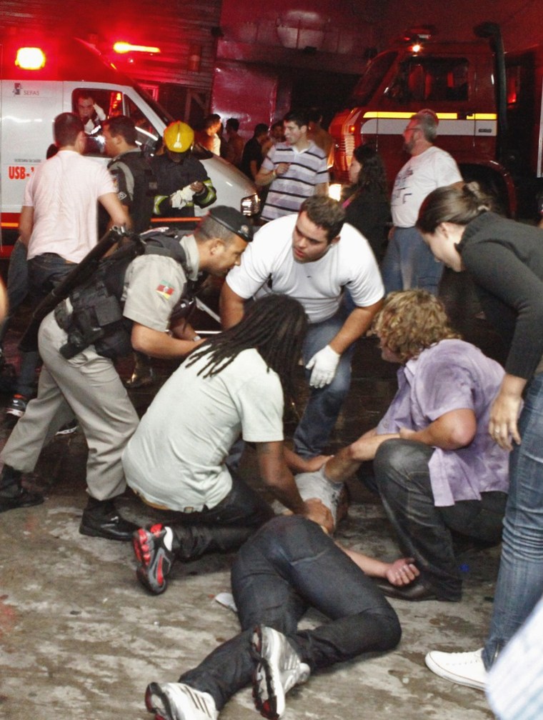 People help a man injured in a nightclub fire in Santa Maria city, Brazil, on Sunday.