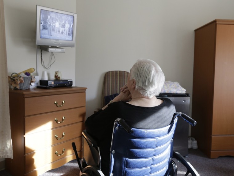 An elderly woman who has suffered abuse by a relative watches