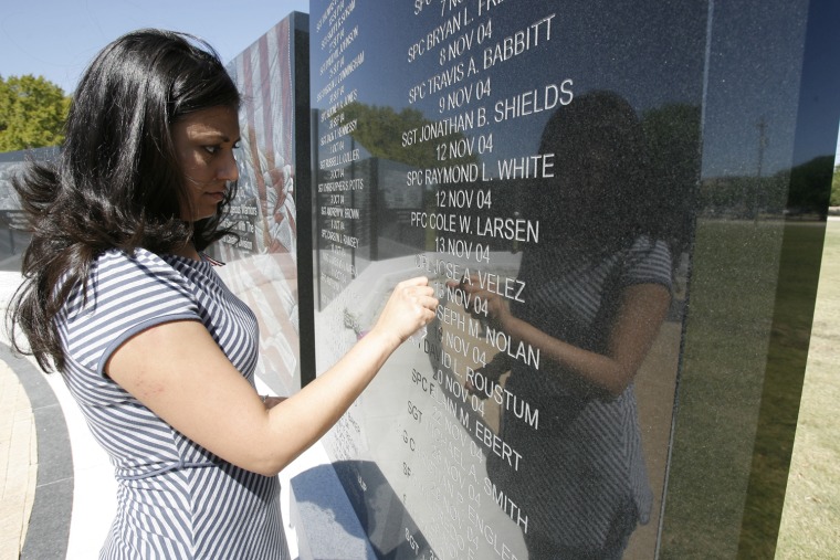 Monica Velez cleans her brother's name, engraved in a memorial at Fort Hood, Texas.