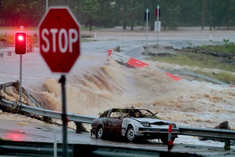 Floodwaters race across the Oxenford - Tamborine road on Australia's Gold Coast on Jan. 28, 2013 as severe floods swept through two states.