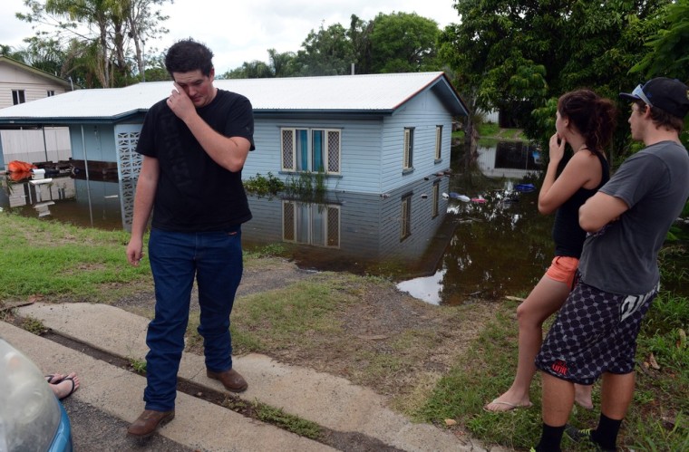 Residents inspect their flooded home in Bundaberg, Queensland, on Jan. 28, 2013. At least 1,200 Bundaberg properties are already flooded, and there are fears the number could reach 2,000.