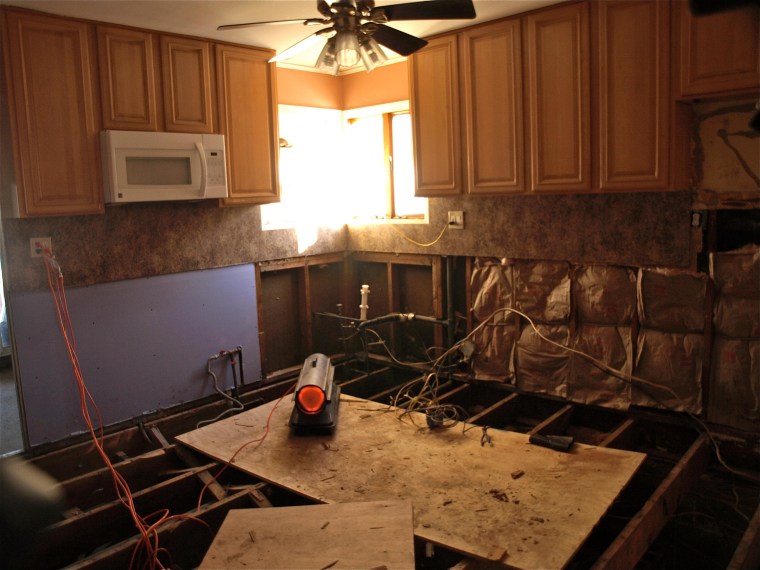 Volunteers helping rebuild Carlos Rodriguez's kitchen found 2 inches of water below the floorboards more than two months after Hurricane Sandy struck the area.