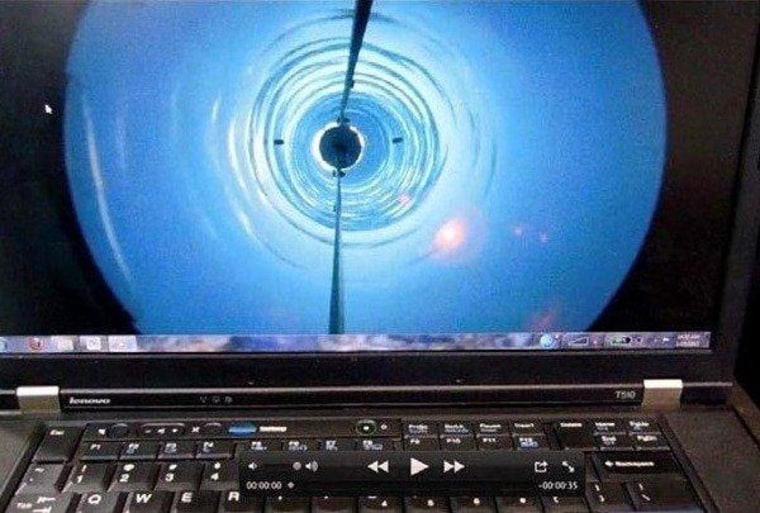 A laptop screen shows a video view of the borehole drilled through Antarctica's ice down to Lake Whillans.