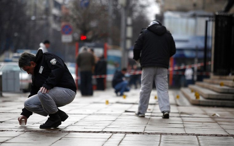 An investigator works at the crime scene where Zlatomir Ivanov was shot in downtown Sofia on Jan. 29, 2013.