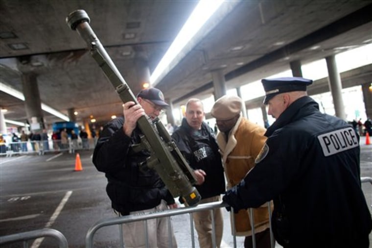 Seattle Police Department officers examine an inert surface to air missile launcher brought to the gun buy back program run by the Seattle Police Department on Saturday, Jan. 26, 2013. The city has collected donations totaling nearly $120,000 to pay for a series of gun buyback events. Participants have been asked to unload and secure their weapons in the trunk of their vehicle or in a locked container.