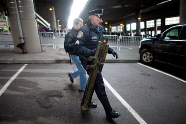 Seattle Police Department Sgt. Paul Gracy holds an inert surface to air missile launcher brought to a gun buy back program run by the Seattle Police Department on Saturday, Jan. 26, 2013.