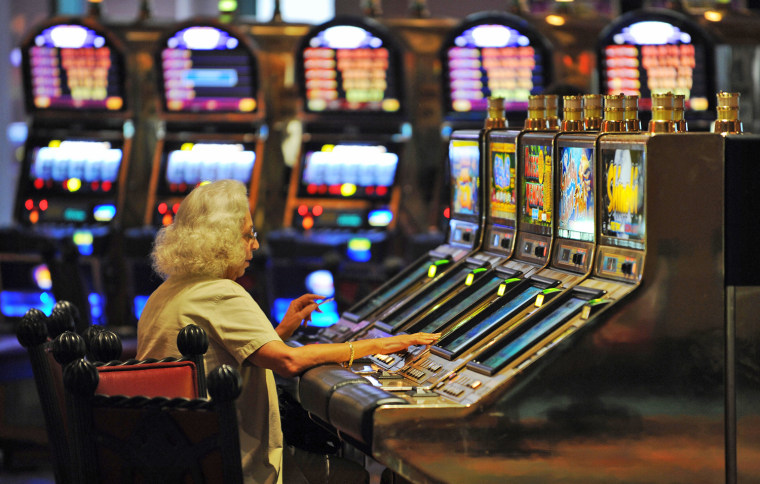 A tourist plays in a casino at a resort in Nassau, Bahamas. Locals are barred from betting in casinos at the islands' tourist resorts.