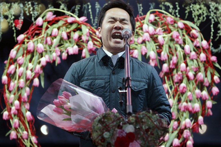 A husband shouts a message of love to his wife in a Tokyo park as part of an annual tradition in which normally reserved men declare their feelings in the most vocal manner.
