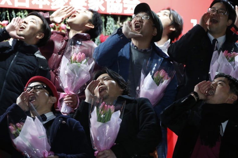Husbands, shouting in unison, declare their love for their wives as part of an event that urges normally staid Japanese men to show their romantic side.