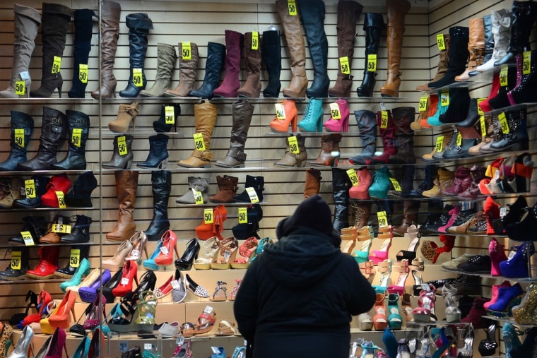 A woman look at shoes on a display sale in New York, January 28, 2013.