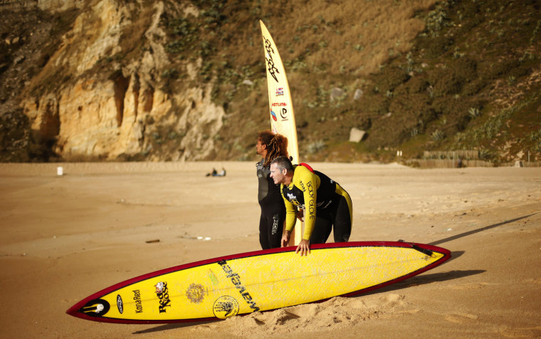 Big-wave surfer Garrett McNamara looks at the sea with his colleague Kealli Mamala before a surf session at Praia do Norte in Nazare, on Jan. 29.
