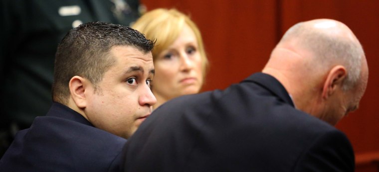 George Zimmerman, left, sits with defense counsel at the Seminole County courthouse Tuesday in Sanford, Fla., on Dec. 11, 2012.