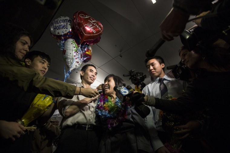 Human rights activist Nguyen Quoc Quan (center left), seen with his wife Huong Mai Ngo and their sons Khoa, 20, and Tri, 19, speaks during a press conference after his arrival at the Los Angeles International Airport from Vietnam on Jan. 30, 2013.