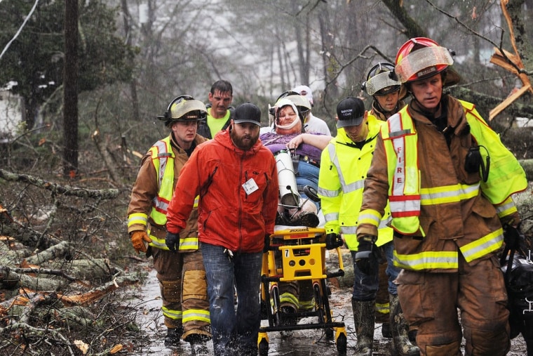 Emergency crews rescue Brenda Mulkey, injured at her home when a suspected tornado touched down in Adairsville, Ga. Wednesday.