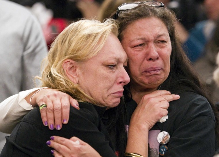 Women whose daughters are part of a missing women's inquiry in Canada cry during discussion of a report, titled 'Forsaken,' that examines the mishandling of the Robert Pickton serial killer case.