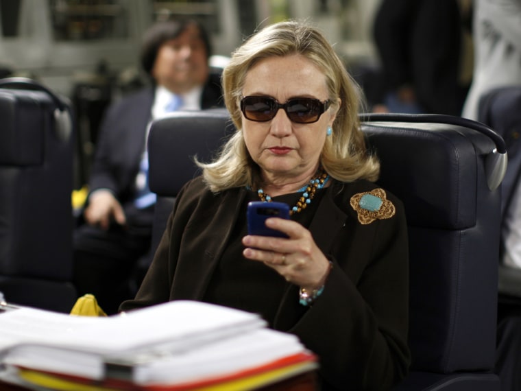 The photo that launched a thousand memes: Hillary Clinton checks her phone on a plane bound for Libya in Oct. 2011.