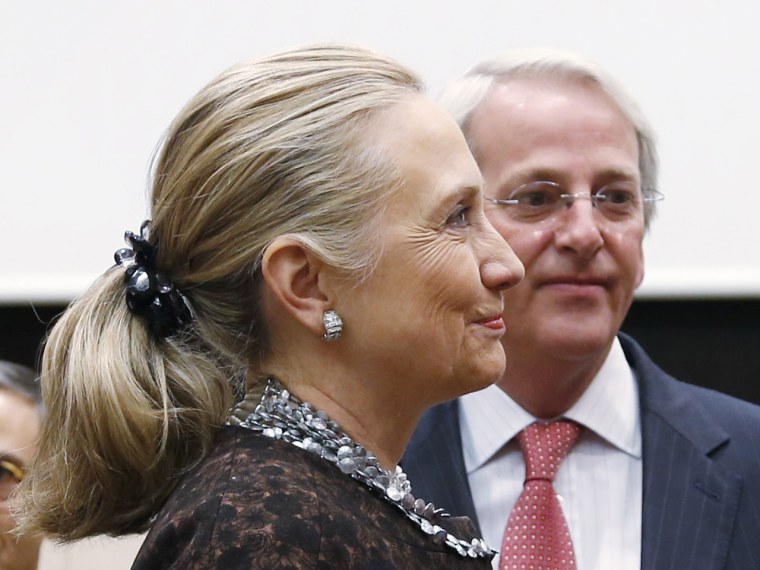 Hillary Clinton (L) listens to Finnish Foreign Minister Erkki Tuomioja in December 2012 wearing one of her famous scrunchies.