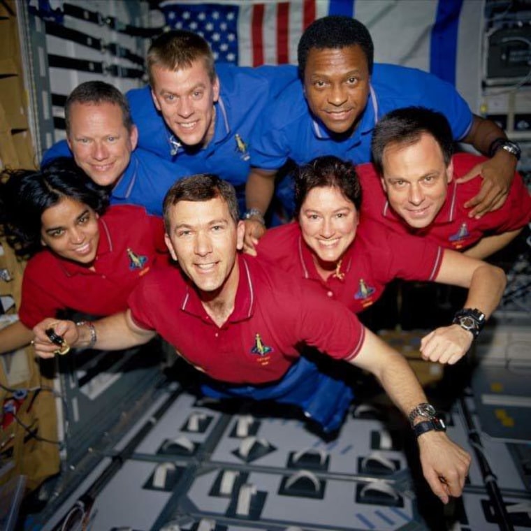 This image of the STS-107 crew in orbit was recovered from wreckage inside an undeveloped film canister. The shirt color's indicate their mission shifts. From left (bottom row): Kalpana Chawla, mission specialist; Rick Husband, commander; Laurel Clark, mission specialist; and Ilan Ramon, payload specialist. From left (top row) are astronauts David Brown, mission specialist; William McCool, pilot; and Michael Anderson, payload commander.