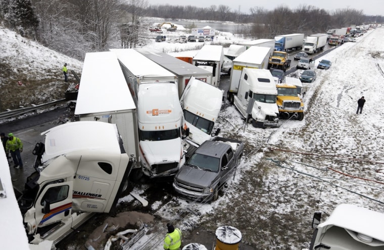 Police and emergency personal work the scene of a pileup involving more than 40 vehicles on I-70 in Plainfield, Ind., Thursday. The crash closed the interstate in both direction and authorities reported at least seven minor injuries.