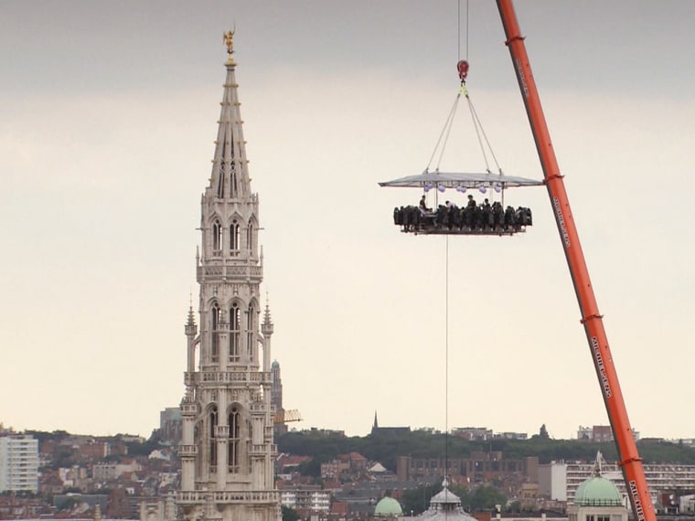 Dinner in the Sky gives patrons a first-class meal they won't forget and hopefully will hold down while suspended 150 feet off the ground, like this group of diners in Brussels. 