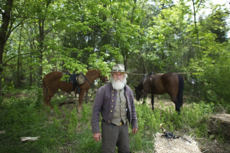 Harold Lawson, of the 2nd Virginia Corps, a member of General Jackson's Core Staff, gazes towards the gathering formations of troops before battle from his camp during the Chancellorsville 150th reenactment in Spotsylvania, VA on May 4, 2013.