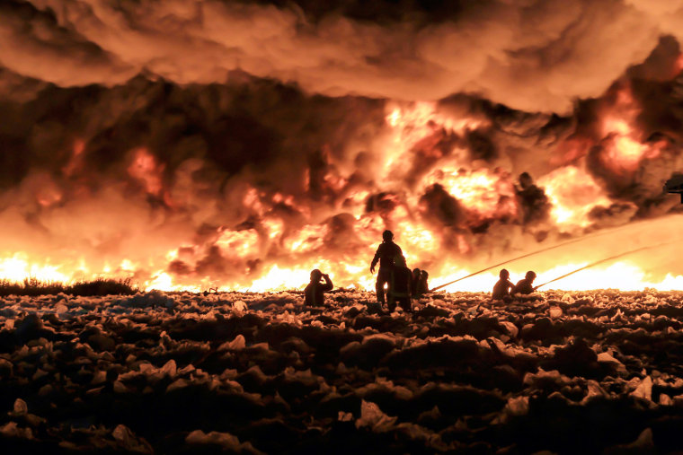 West Midland firefighters tackle a large blaze at a recycling plant called J & A Young, Dartmouth Road, Smethwick, England on July 1, 2013. More than 150 firefighters worked on the blaze involving 100,000 tons of plastic recycling material sending a plume of smoke is rising 6,000 feet into the air.