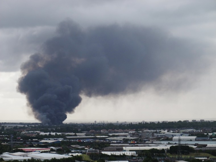 Smoke rises from a fire at a recycling plant in Smethwick, Birmingham, England on July 1, 2013.