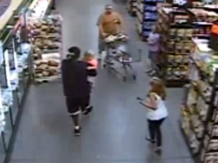 The scene in the store as Wallace walks away holding Zoey, captured on surveillance video.