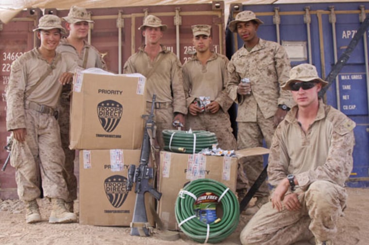 U.S. servicemen in Afghanistan distribute a shipment from Troops Direct, an online charity based in San Ramon, CA