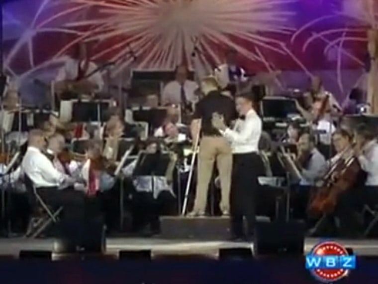Boston Pops conductor Keith Lockhart (in white) introduced Donohue as a \"the living embodiment of an everyday hero\" before he led a rendition of the Dropkick Murphys' \"I'm Shipping Up to Boston.\"