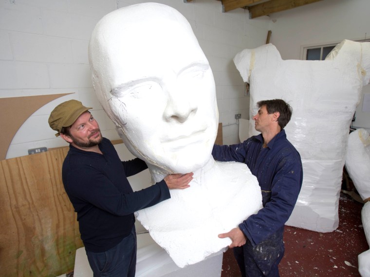 Artists Toby Crowther and Andy Billetto help construct the 12-foot statue of Pride and Prejudice's dashing hero, Mr. Darcy.
