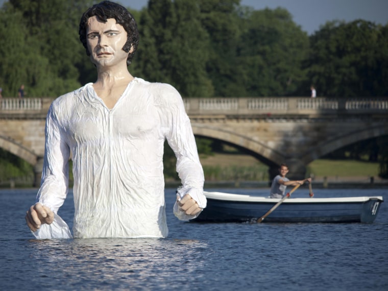 A passerby takes a look at the 12-foot Mr. Darcy.