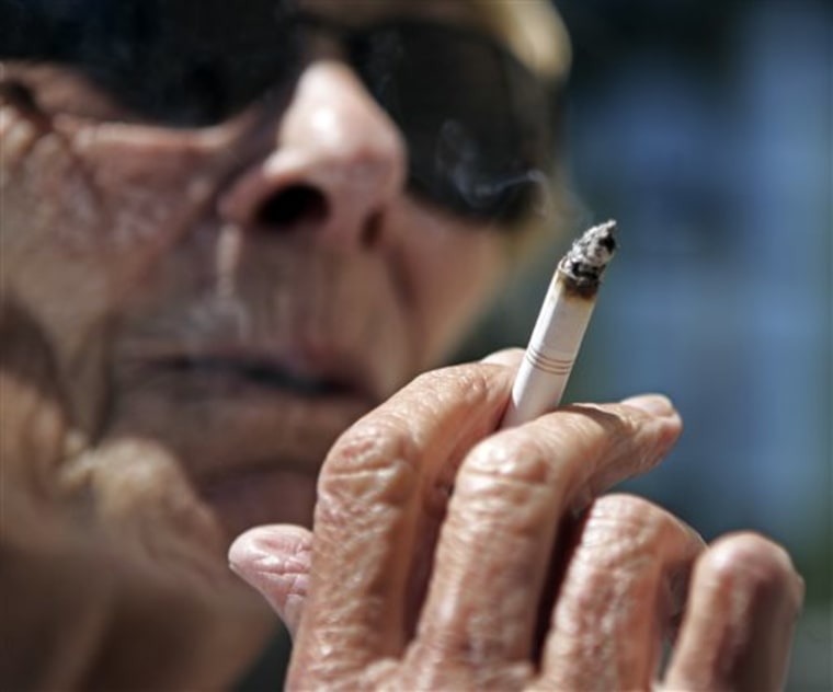 FILE - In this June 11, 2007 file photo, Helen Heinlo smokes outside of a coffee shop in Belmont, Calif. Some smokers trying to get coverage in 2014 ...
