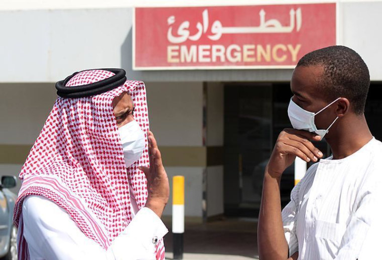 Men wearing surgical masks as a precautionary measure against the novel coronavirus, speak at a hospital in Khobar city in Dammam May 23, 2013. REUTER...