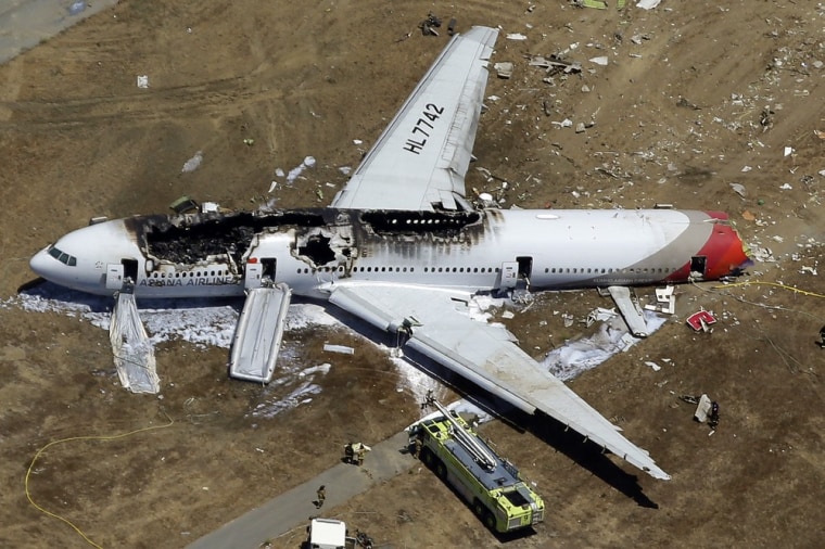 In this Saturday, July 6, 2013 aerial photo, the wreckage of Asiana Flight 214 lies on the ground after it crashed at the San Francisco International ...