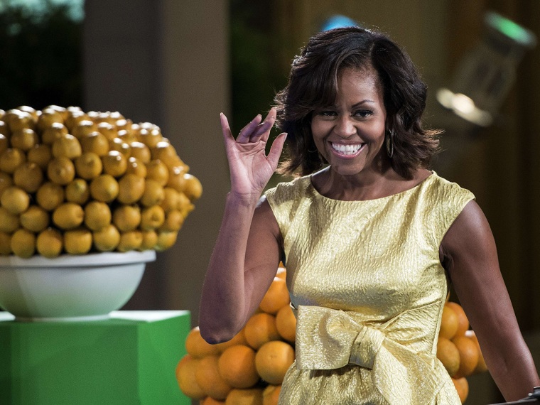 US first lady Michelle Obama arrives during a kids' state dinner in the East Room Room of the White House July 9, 2013 in Washington, DC. President Ob...