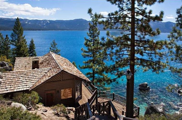 The 2,518-square-foot home sits on five parcels and includes a guest cottage, for a total of 5 bedrooms and 4 baths within the estate. Expansive views of the lake are captured from the wrap-around deck, which also holds a hot tub.