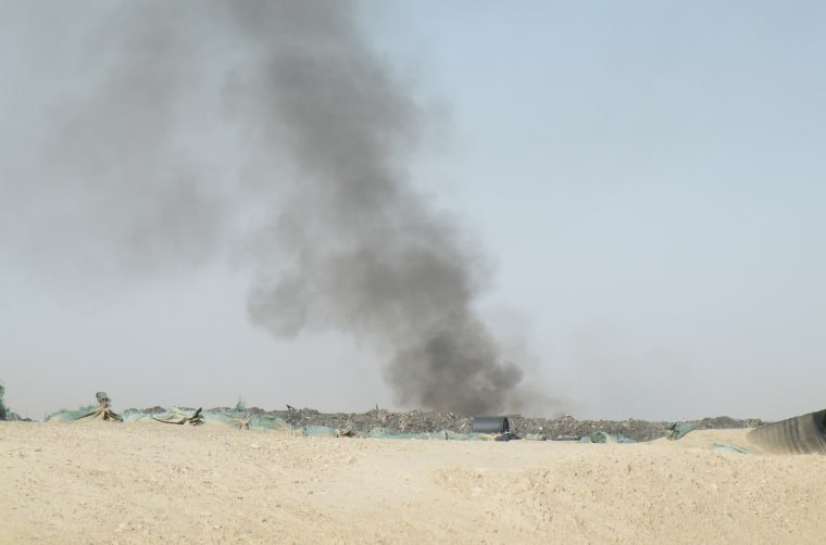A burn pit smolders near Camp Leatherneck, a U.S.Marine base in Helmand Province, Afghanistan.